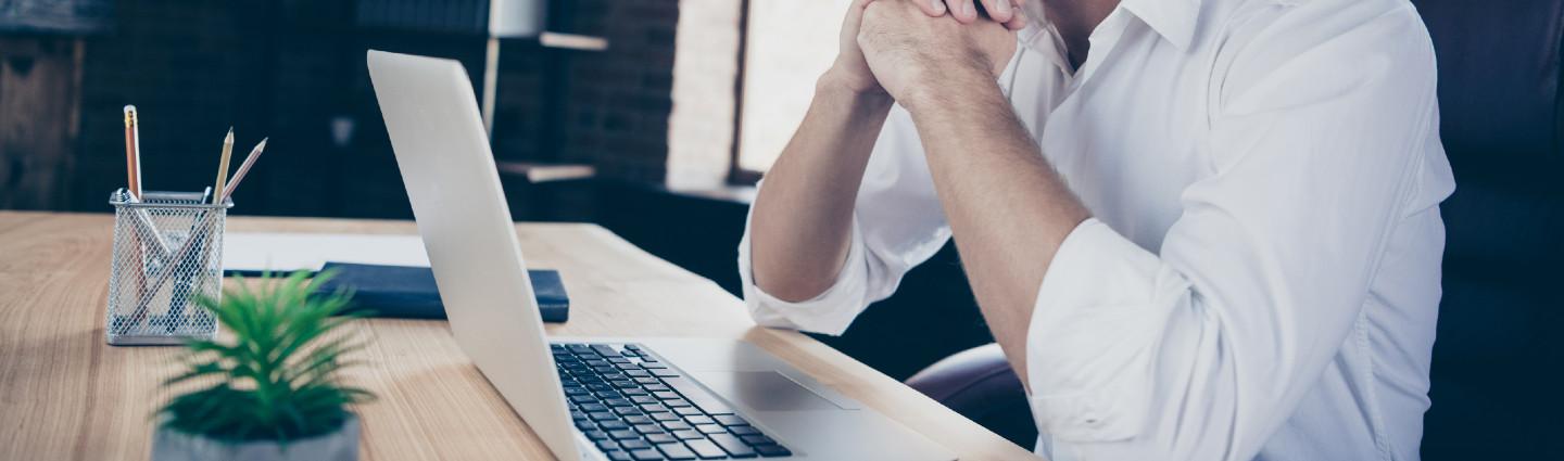 A man sitting in front of a laptop
