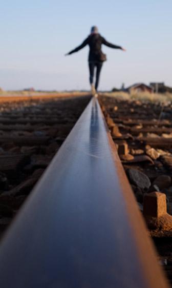 A person walking on train tracks