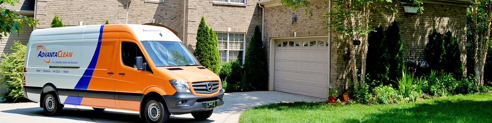 AdvantaClean truck driving outside a house