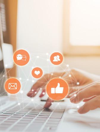 Typing on a computer with social media icons